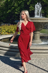 a lady wears a red maxi dress with polka dots print